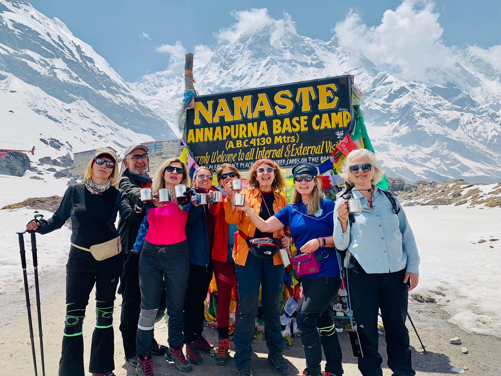 trekkers-annapurna-base-camp-mountain-range.jpeg Trekkers at Annapurna Base Camp surrounded by the Annapurna mountain range